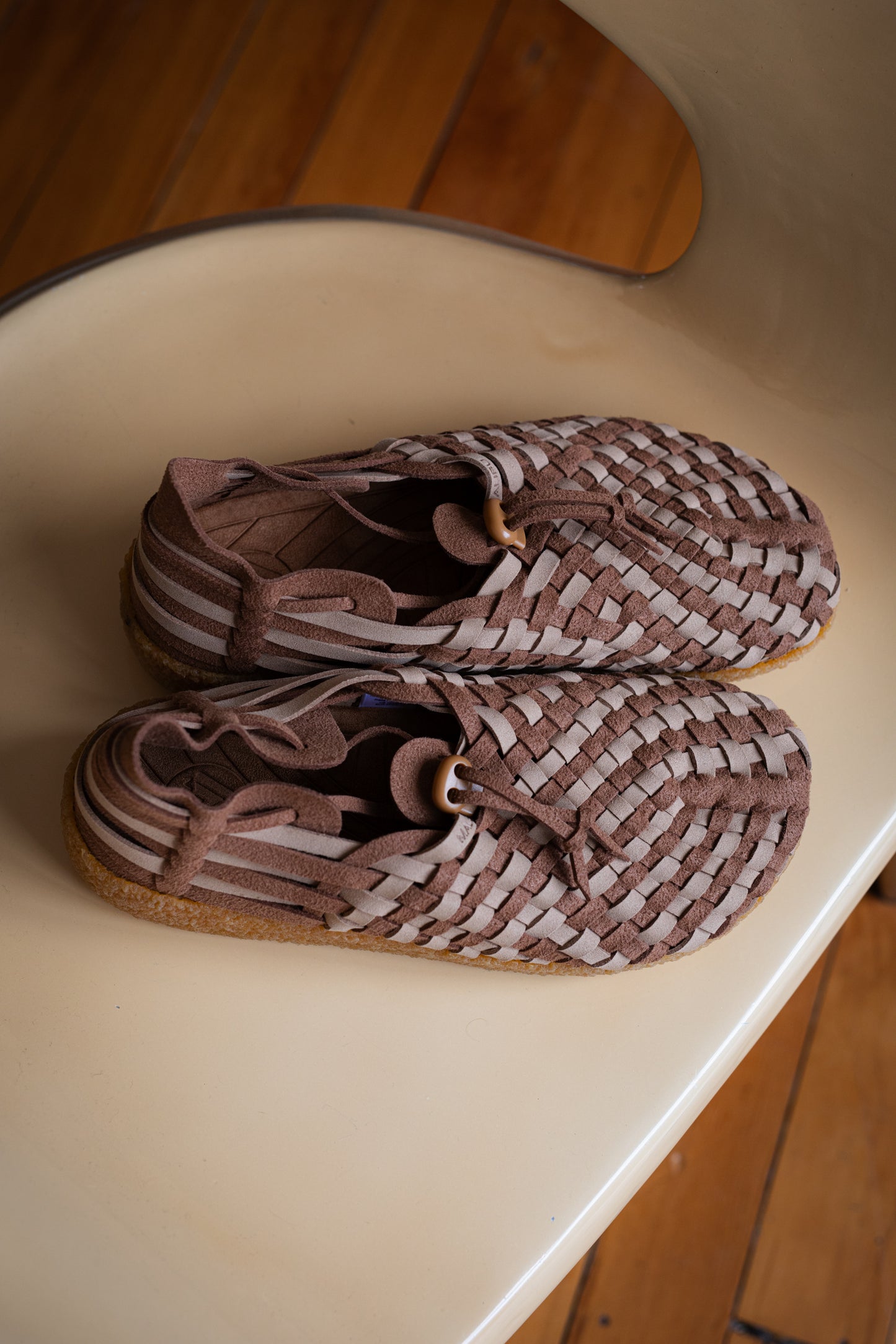 up close photo of Malibu Sandals Latigo two tone vegan suede on a birch chair. 