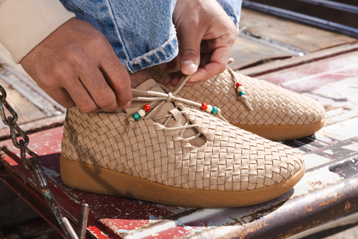 Close up photo of all new Malibu Sandals Matador Low Woven chukka in beige with beads at the tips of the laces