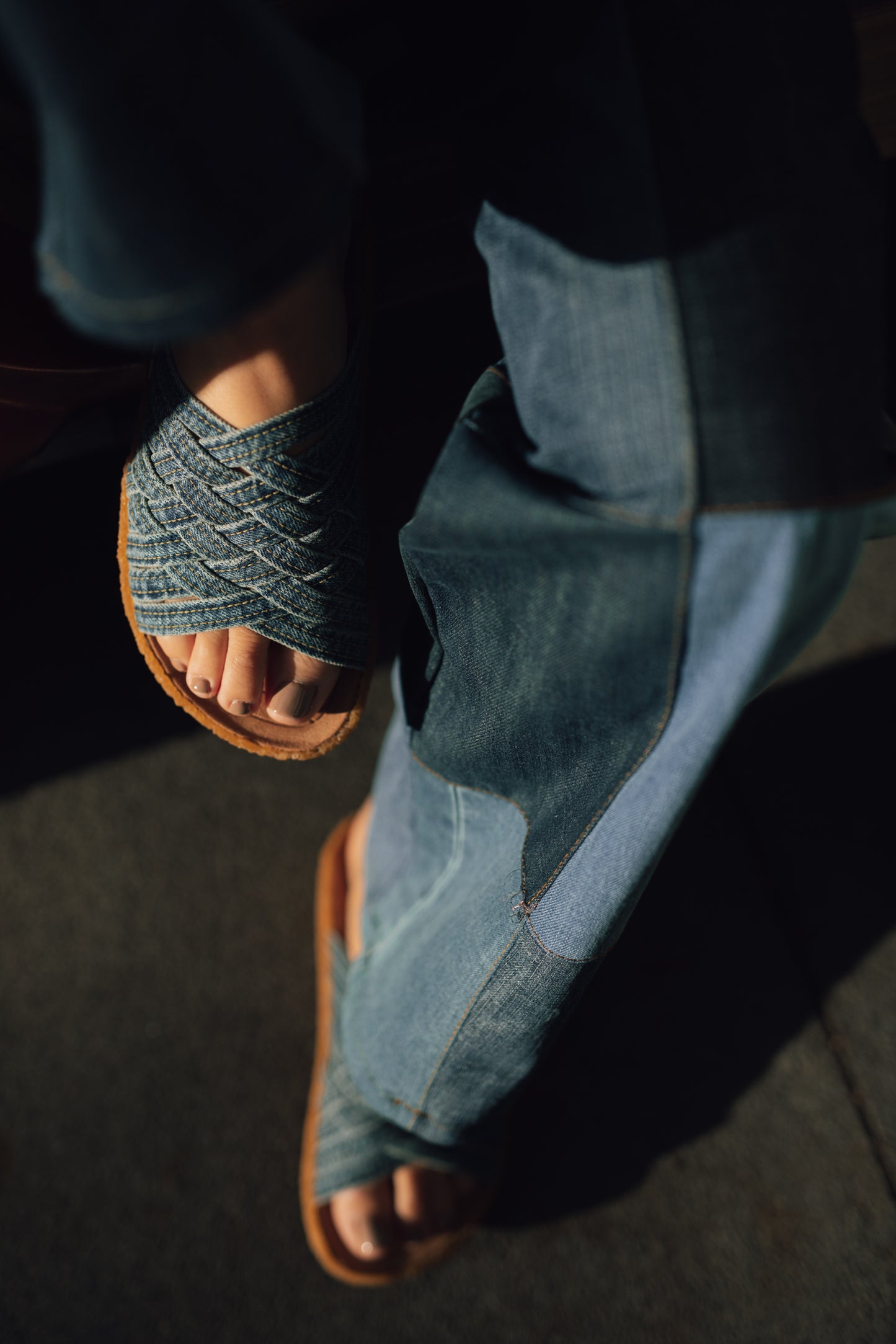 Close up photo of collaborative orSlow x Malibu Sandals washed indigo Zuma with crepe sole with sunset lighting